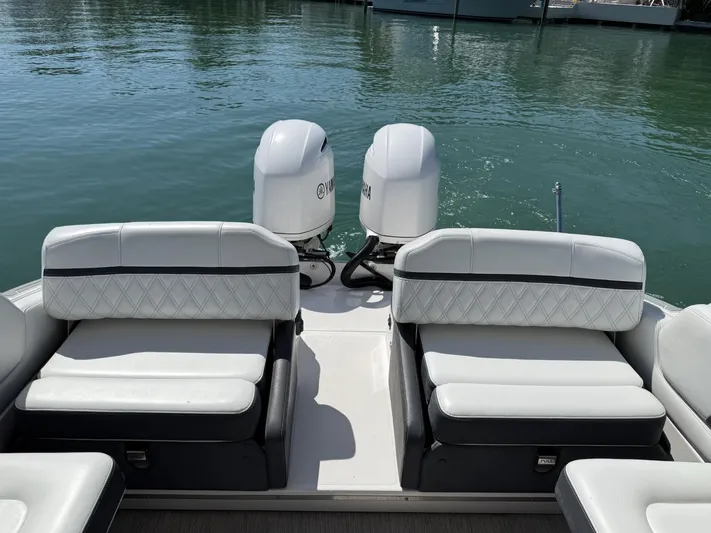  Yacht Photos Pics 2019 Regal 29 OBX boat with dual outboard engines and white seating on calm water.