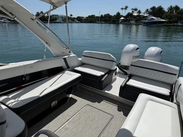  Yacht Photos Pics 2019 Regal 29 OBX boat interior with seating, on a calm waterfront.