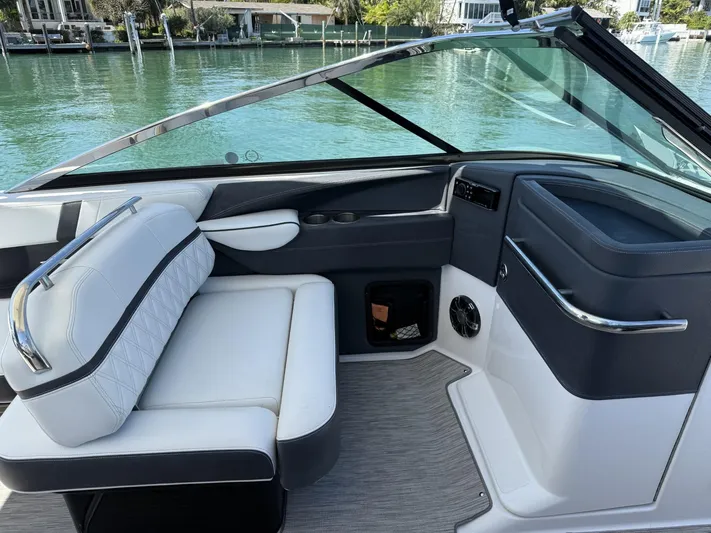  Yacht Photos Pics 2019 Regal 29 OBX boat interior with white seating and sleek dashboard design.