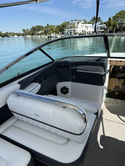  Yacht Photos Pics 2019 Regal 29 OBX boat interior with white seating, on a calm waterfront.