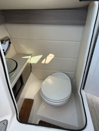  Yacht Photos Pics 2019 Regal 29 OBX boat interior bathroom with modern design and compact toilet.