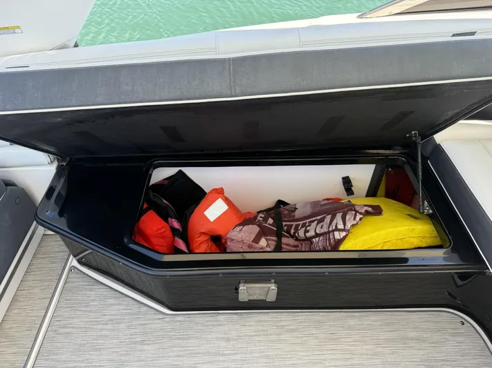 Yacht Photos Pics Open storage compartment on 2019 Regal 29 OBX boat with life jackets and gear.