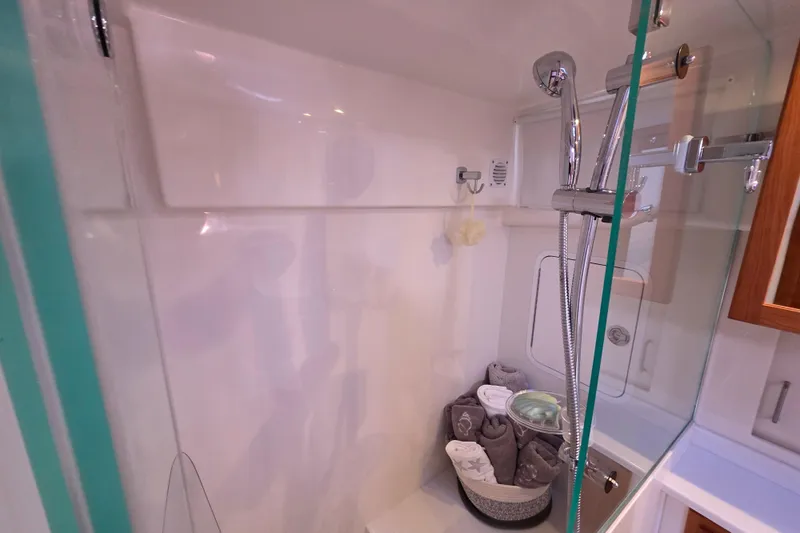  Yacht Photos Pics 2022 Back Cove 372 yacht bathroom with modern shower and neatly arranged towels.