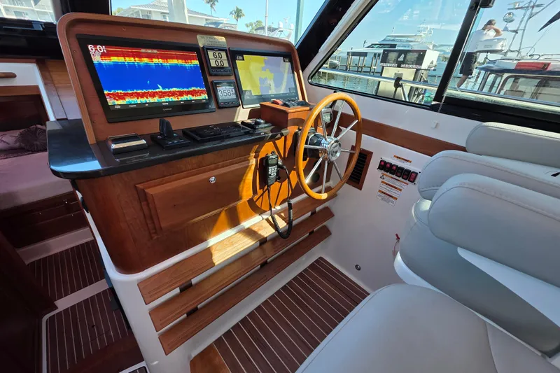  Yacht Photos Pics 2022 Back Cove 372 helm with navigation screens, wooden steering wheel, and comfortable seating.