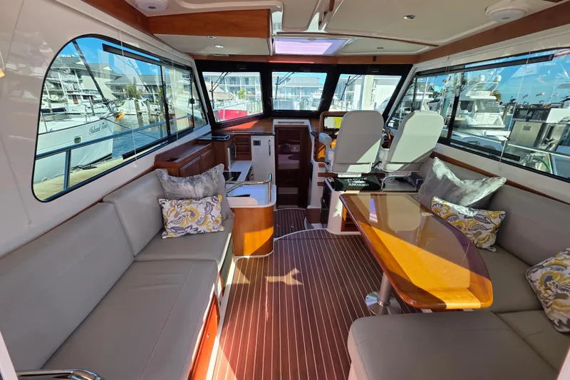  Yacht Photos Pics Luxurious interior of 2022 Back Cove 372 yacht with elegant seating and wooden accents.