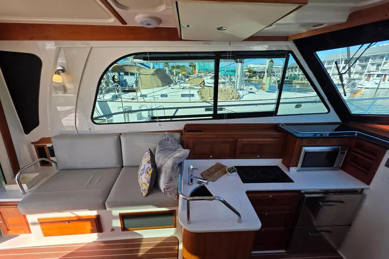  Yacht Photos Pics Interior of 2022 Back Cove 372 yacht with modern kitchen and seating area.