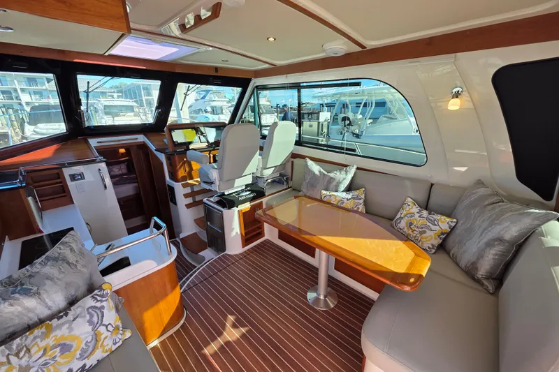  Yacht Photos Pics Luxurious interior of 2022 Back Cove 372 yacht with elegant seating and helm station.