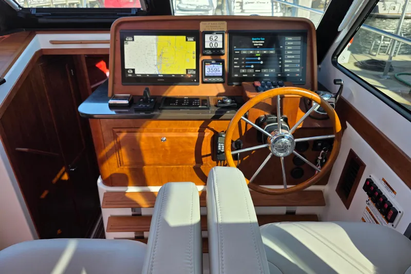  Yacht Photos Pics 2022 Back Cove 372 helm with wooden steering wheel and modern navigation displays.