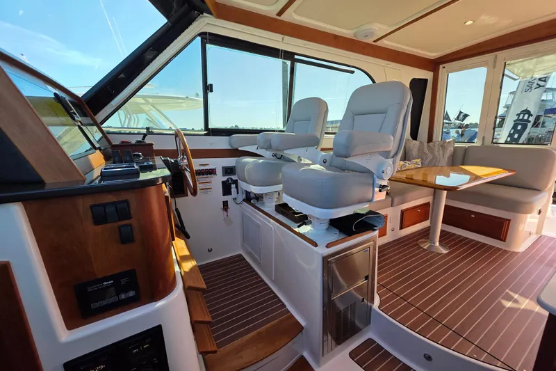  Yacht Photos Pics Interior of 2022 Back Cove 372 yacht with helm seats and dining area.