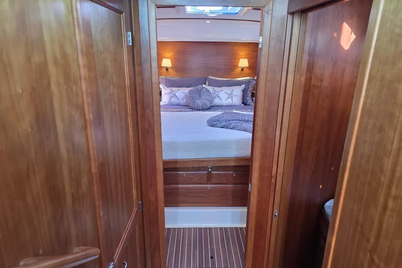  Yacht Photos Pics 2022 Back Cove 372 yacht cabin with cozy bed and wooden interior.