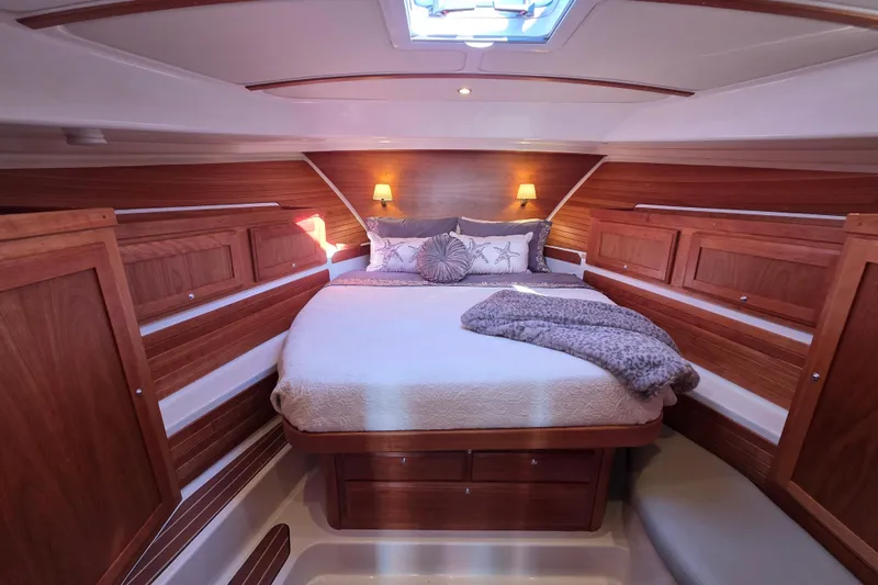  Yacht Photos Pics Luxurious cabin interior of 2022 Back Cove 372 yacht with cozy bed and wooden accents.