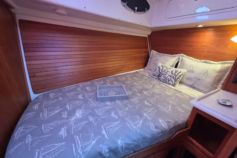  Yacht Photos Pics Cozy cabin interior of 2022 Back Cove 372 with nautical-themed bedding.