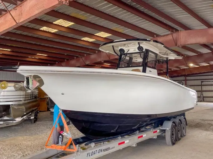  Yacht Photos Pics 2025 Sea Pro 322 Offshore boat on trailer in covered storage.