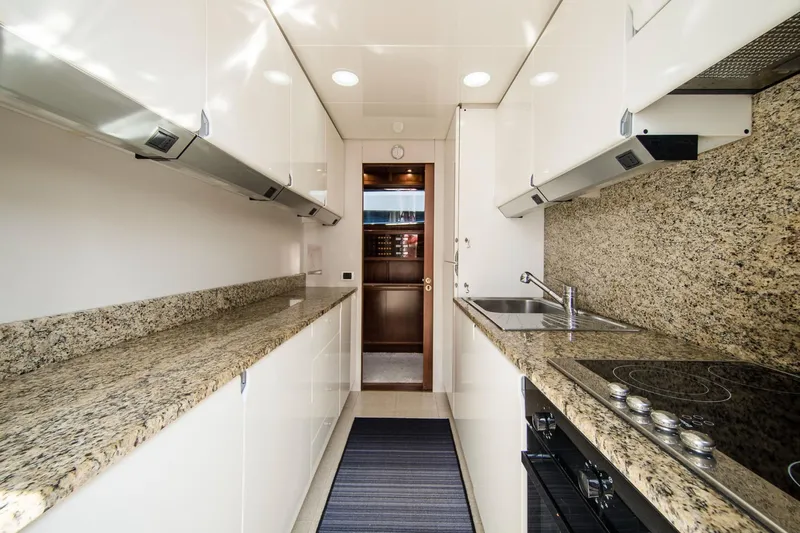  Yacht Photos Pics Luxurious kitchen interior of 1998 Sanlorenzo SL72 yacht with granite countertops.
