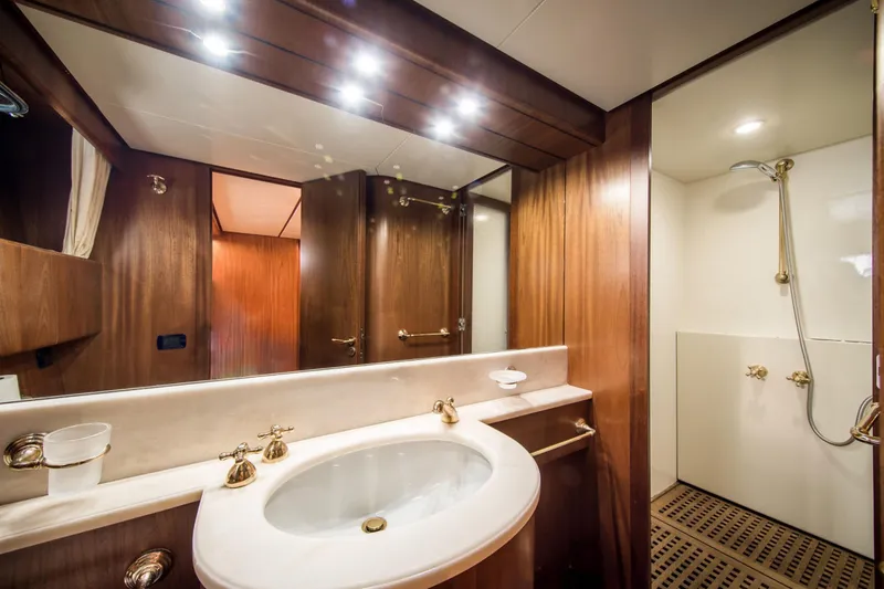  Yacht Photos Pics Luxurious bathroom on 1998 Sanlorenzo SL72 yacht with wood accents and modern fixtures.