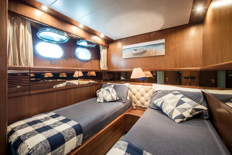  Yacht Photos Pics Luxurious cabin interior of 1998 Sanlorenzo SL72 yacht with twin beds and nautical decor.