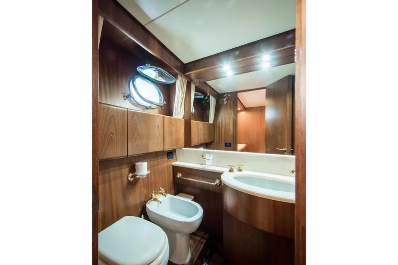  Yacht Photos Pics Luxurious bathroom in 1998 Sanlorenzo SL72 yacht with wood accents and elegant fixtures.