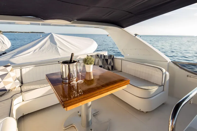  Yacht Photos Pics Luxurious 1998 Sanlorenzo SL72 yacht deck with seating, table, and ocean view.