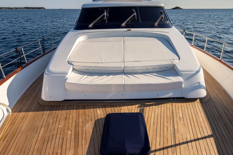  Yacht Photos Pics Sanlorenzo SL72 1998 yacht deck with sunbed, cruising on open sea.