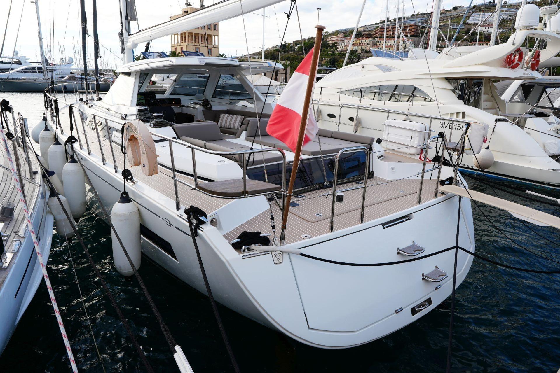 2023 Amel 50 yacht docked in marina, featuring sleek design and spacious deck.