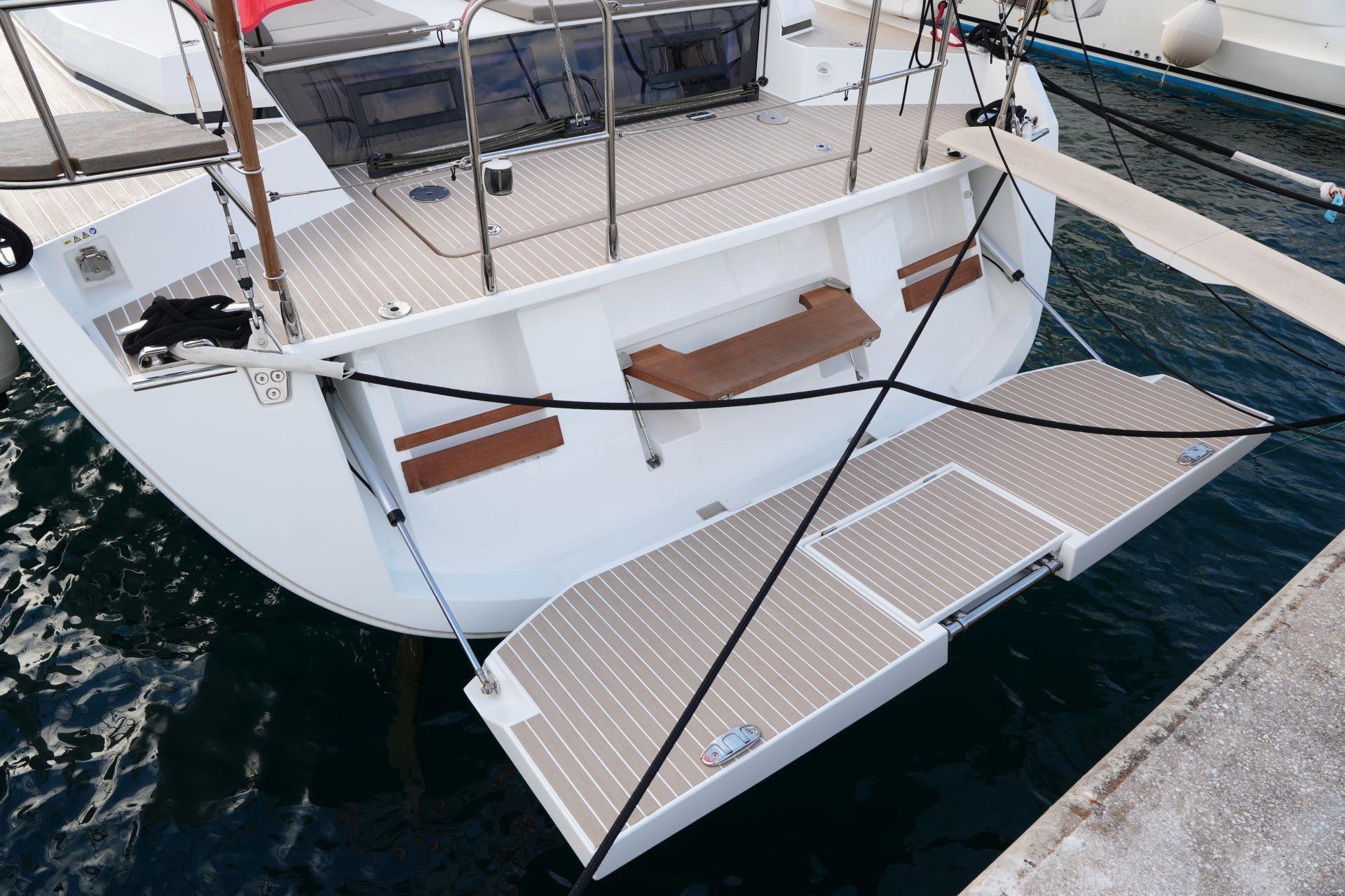 2023 Amel 50 yacht stern with open swim platform and teak decking.