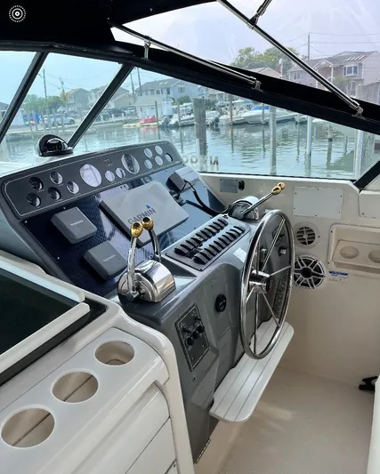  Yacht Photos Pics 1997 Tiara Yachts 4000 Express helm with controls and steering wheel, dockside view.