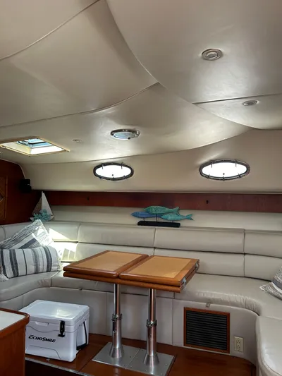  Yacht Photos Pics Interior of 1997 Tiara Yachts 4000 Express with plush seating and wooden table.
