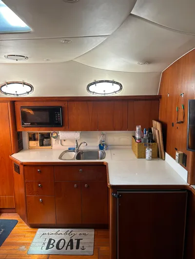  Yacht Photos Pics 1997 Tiara Yachts 4000 Express interior kitchen with wood cabinets and modern amenities.