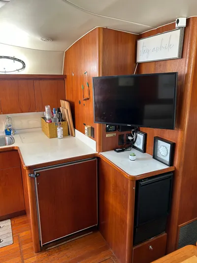  Yacht Photos Pics 1997 Tiara Yachts 4000 Express interior with wood cabinetry and mounted TV.
