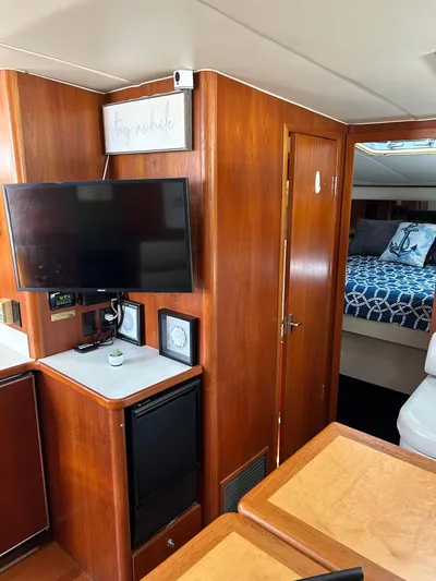 Yacht Photos Pics Interior of 1997 Tiara Yachts 4000 Express with TV, wood paneling, and cozy bedroom.