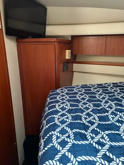  Yacht Photos Pics 1997 Tiara Yachts 4000 Express cabin interior with bed and TV.