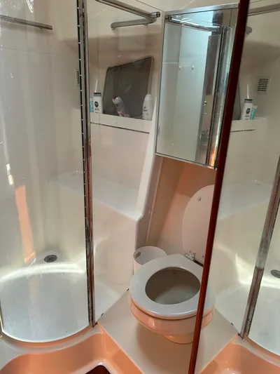  Yacht Photos Pics Bathroom interior of 1997 Tiara Yachts 4000 Express, featuring shower and toilet.
