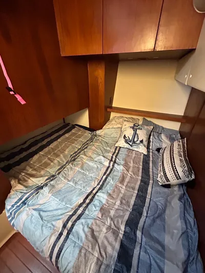  Yacht Photos Pics Cozy cabin interior of 1997 Tiara Yachts 4000 Express with nautical-themed bedding.