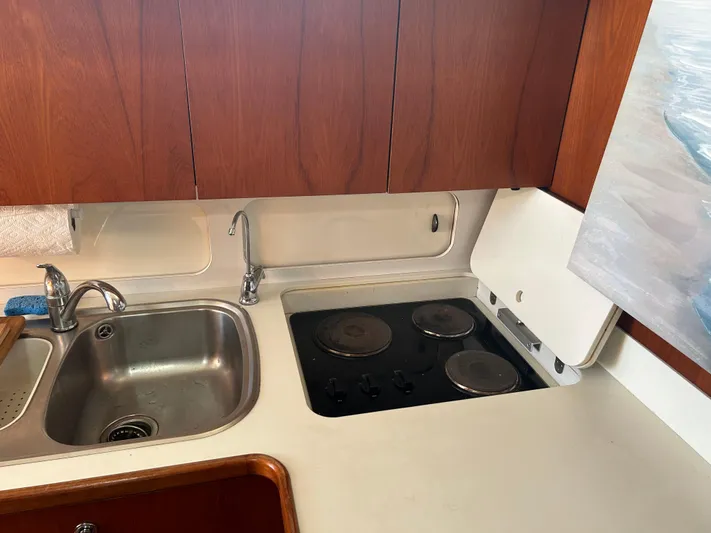  Yacht Photos Pics 1997 Tiara Yachts 4000 Express kitchen with sink and stovetop.