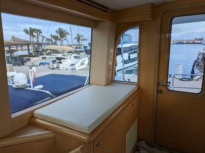  Yacht Photos Pics Interior view of 2001 Hatteras 70 Convertible yacht with marina background.