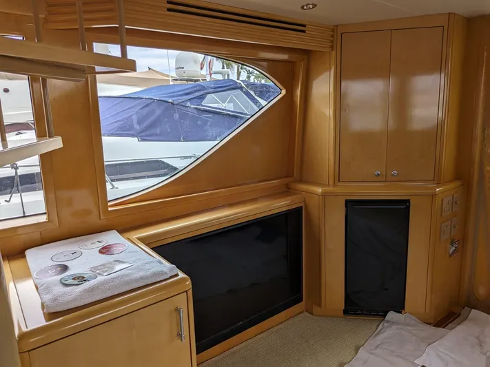  Yacht Photos Pics Interior of 2001 Hatteras 70 Convertible yacht with wooden cabinetry and large window.