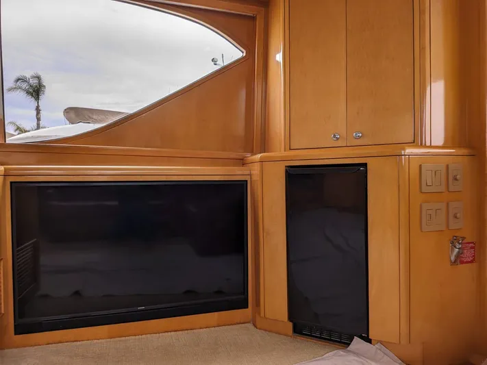  Yacht Photos Pics Interior of 2001 Hatteras 70 Convertible yacht with TV and cabinetry.