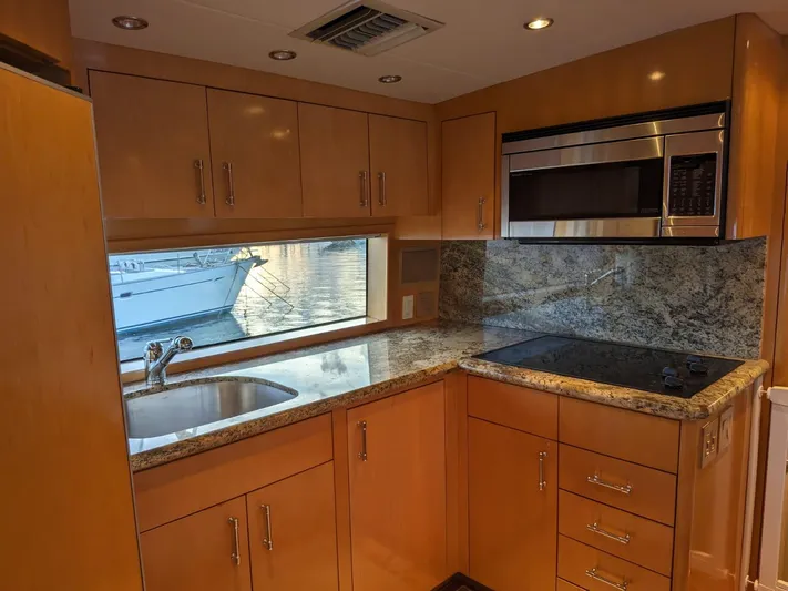  Yacht Photos Pics Modern kitchen in a 2001 Hatteras 70 Convertible yacht with granite countertops.