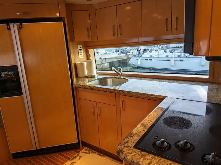  Yacht Photos Pics Modern kitchen in 2001 Hatteras 70 Convertible yacht with marina view.