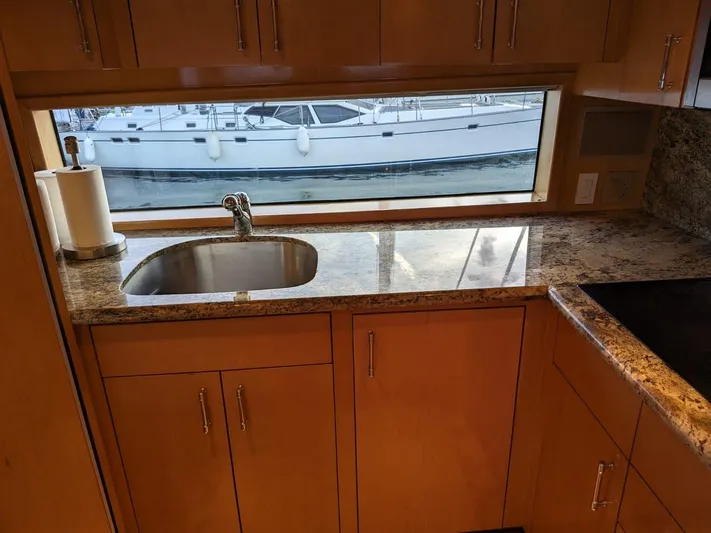  Yacht Photos Pics 2001 Hatteras 70 Convertible yacht kitchen with granite countertops and stainless steel sink.