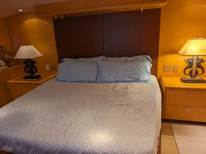  Yacht Photos Pics Master bedroom in 2001 Hatteras 70 Convertible yacht with bed and nightstands.