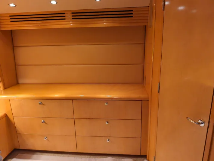  Yacht Photos Pics Interior of 2001 Hatteras 70 Convertible yacht with wooden cabinetry and drawers.