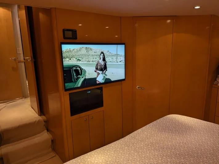  Yacht Photos Pics Interior of 2001 Hatteras 70 Convertible yacht with TV and wooden cabinetry.