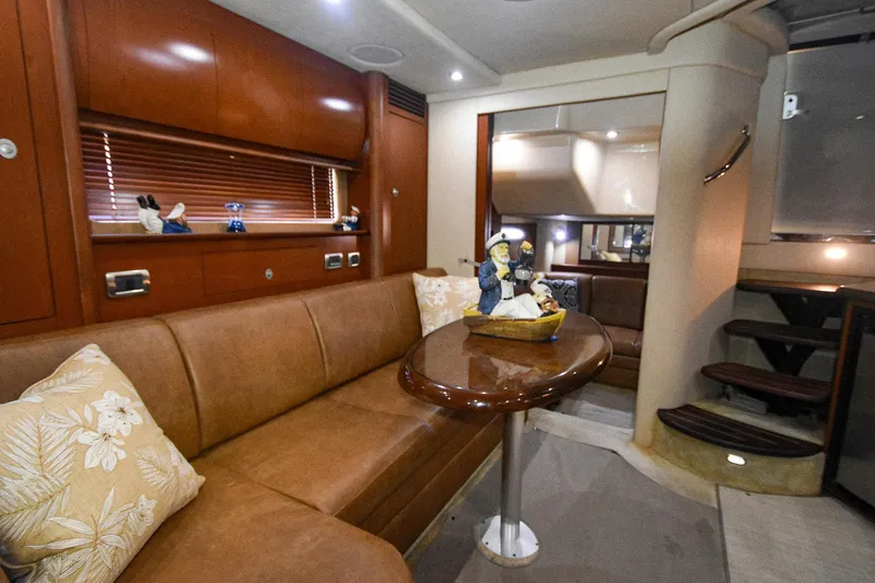 Pure Fun Yacht Photos Pics Luxurious interior of 2007 Sea Ray 40 Sundancer yacht with leather seating and wooden accents.