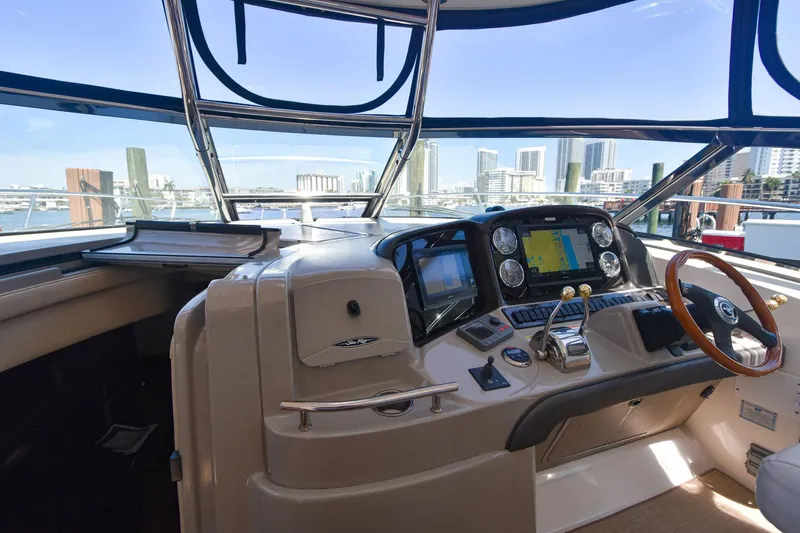 Pure Fun Yacht Photos Pics Helm of 2007 Sea Ray 40 Sundancer yacht with city skyline view.