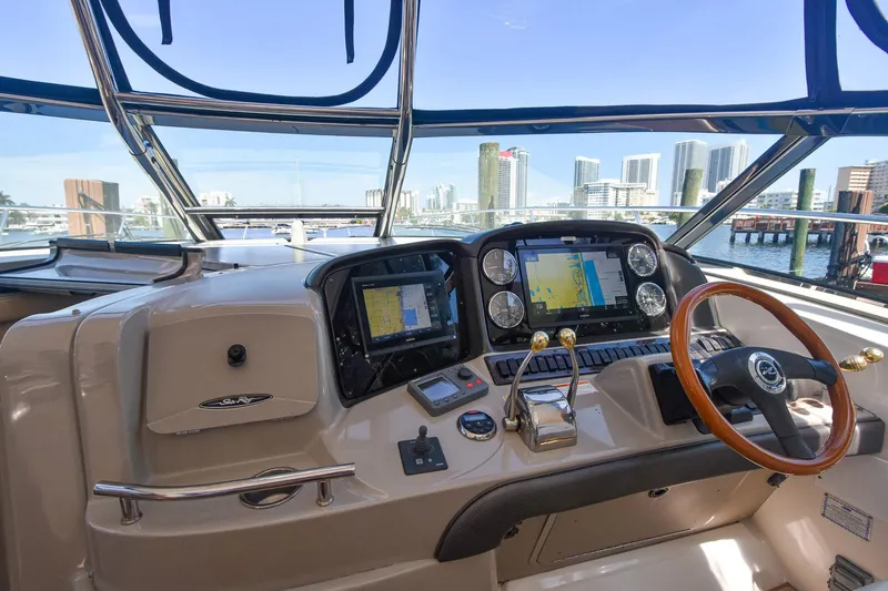 Pure Fun Yacht Photos Pics Helm of 2007 Sea Ray 40 Sundancer with city skyline view.