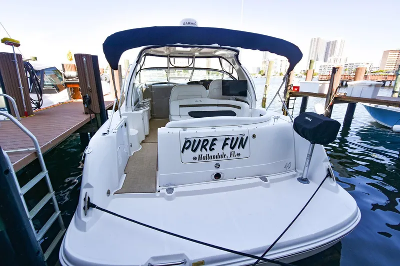 Pure Fun Yacht Photos Pics 2007 Sea Ray 40 Sundancer docked, rear view with "Pure Fun" signage.