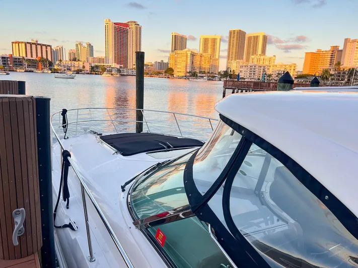Pure Fun Yacht Photos Pics 2007 Sea Ray 40 Sundancer docked with city skyline in background.