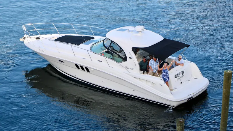 Pure Fun Yacht Photos Pics 2007 Sea Ray 40 Sundancer yacht cruising with passengers on a sunny day.