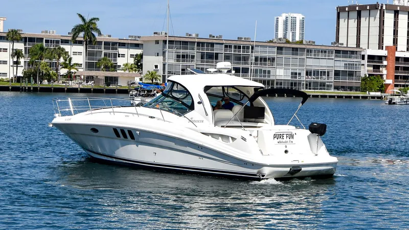 Pure Fun Yacht Photos Pics 2007 Sea Ray 40 Sundancer yacht cruising in a scenic waterfront area.